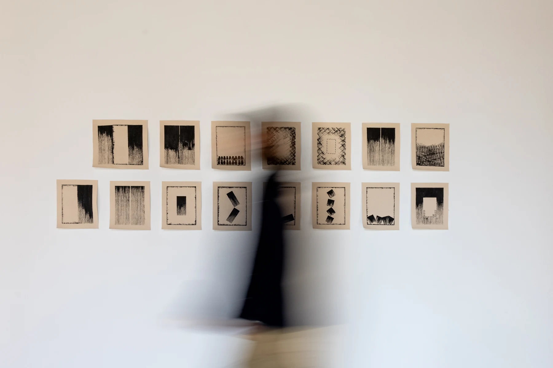 Khalfa installation with a visitor moving past the work.