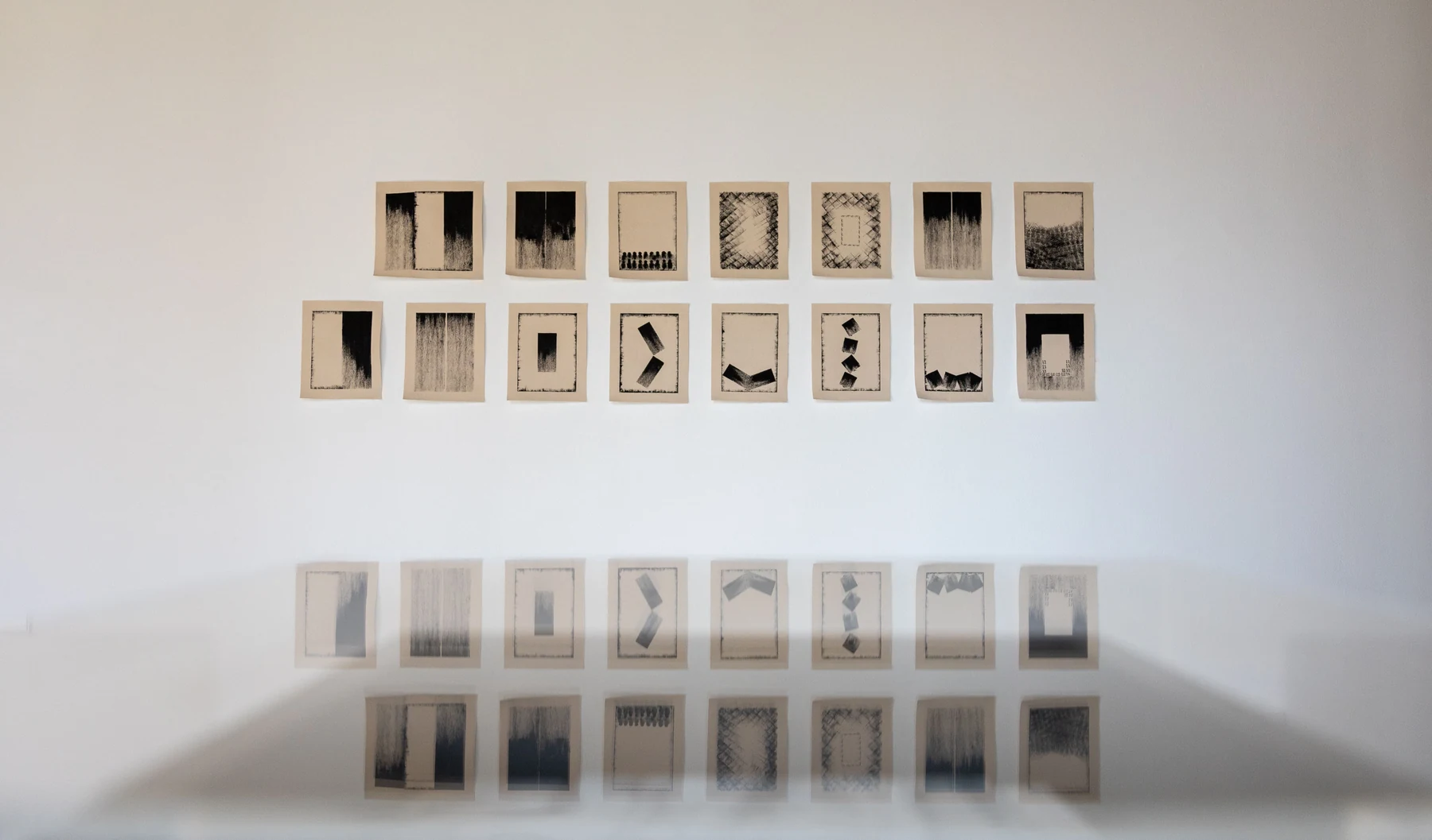 Khalfa series reflected in the gallery floor.