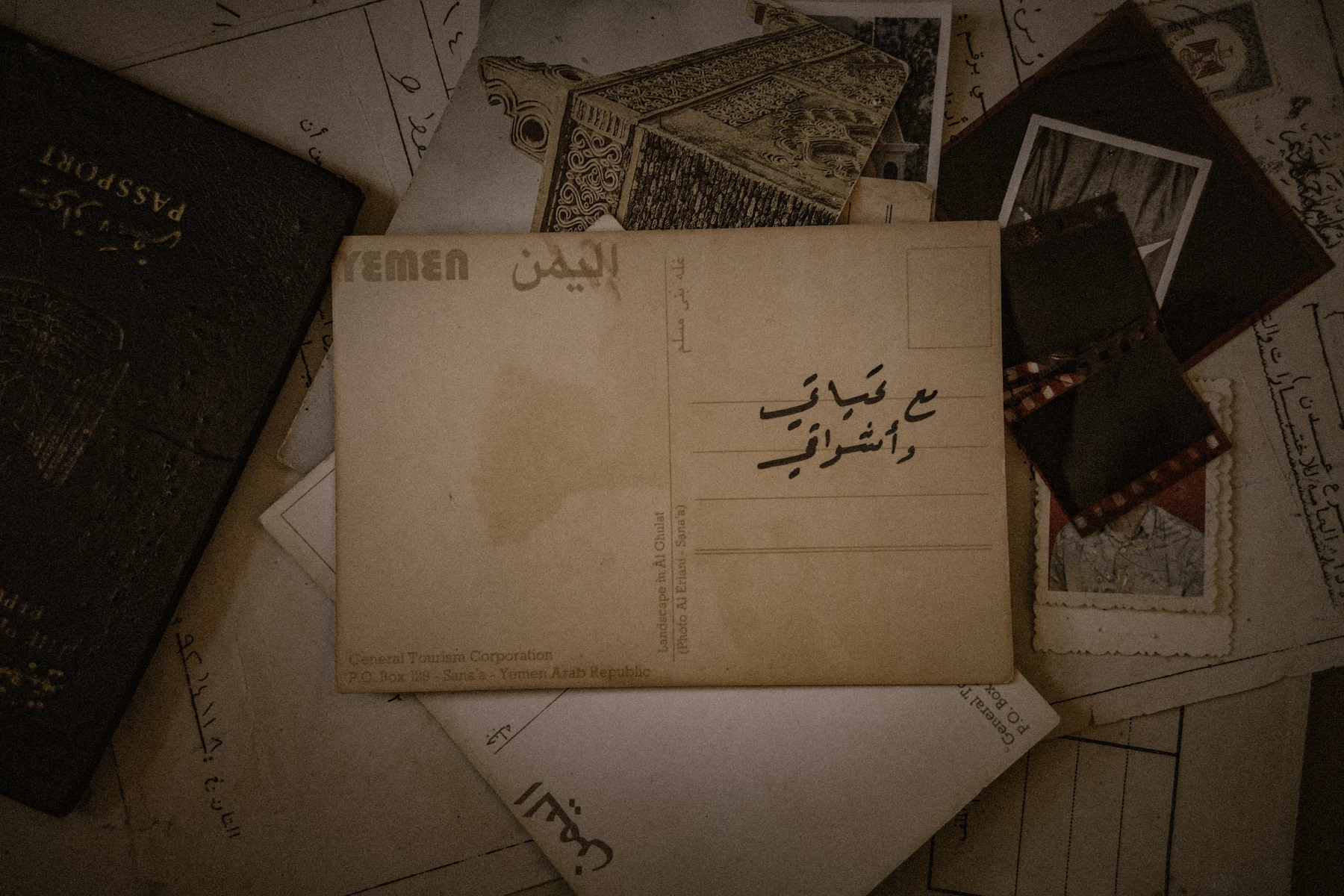 Old passports and paper documents arranged around a vintage envelope.